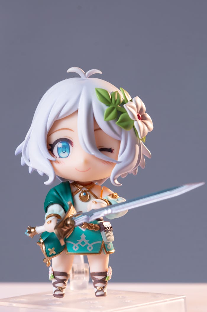 services-01 Cute anime action figure with white hair holding a sword, featuring detailed design elements.